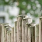 Close-up of wooden fence posts with a blurred background
