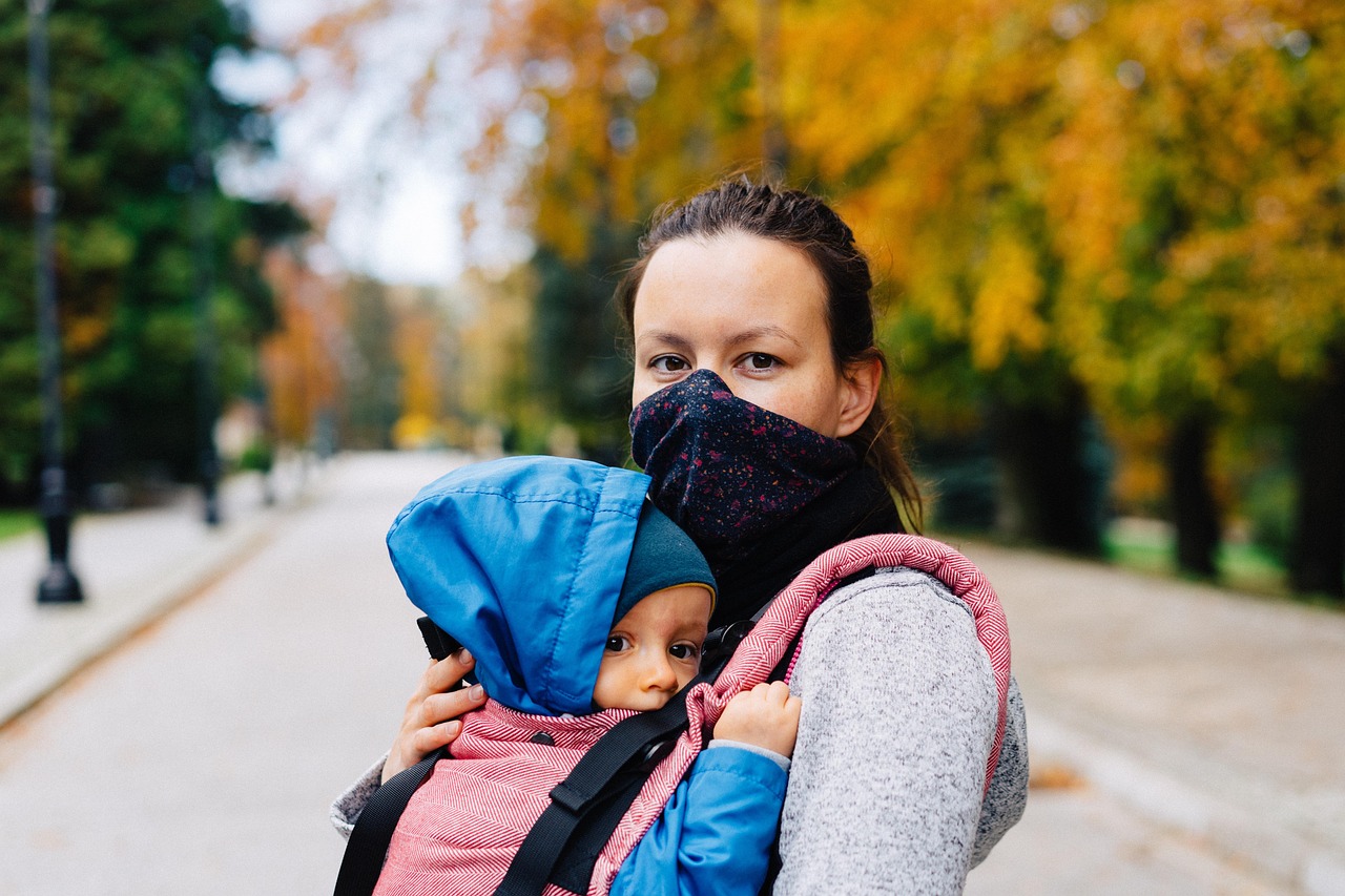 Woman, child, face mask — "Risks and Rewards: A Comprehensive Look at UK Steroid Use"